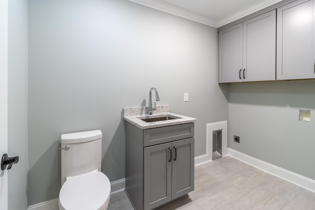 laundry area featuring hookup for a washing machine, crown molding, electric dryer hookup, and sink