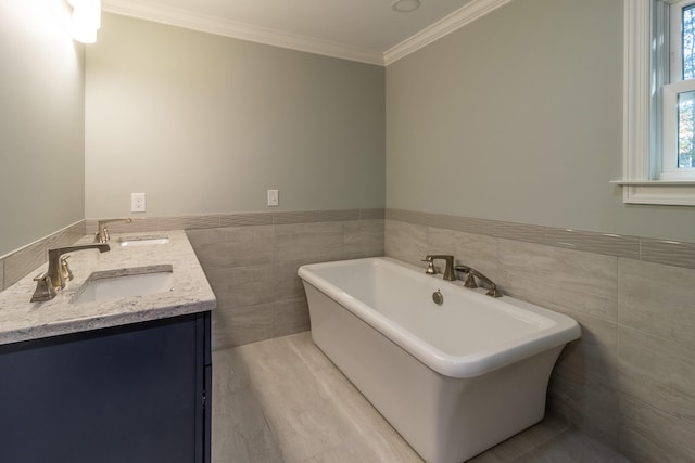 bathroom featuring hardwood / wood-style flooring, vanity, crown molding, tile walls, and a bath