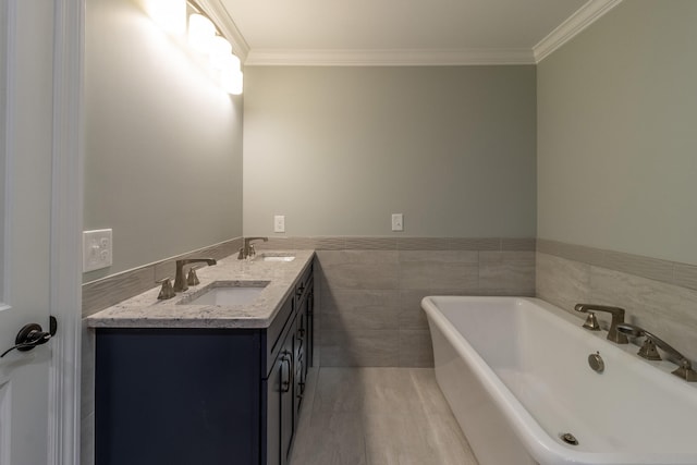 bathroom with a tub, wood-type flooring, tile walls, vanity, and crown molding