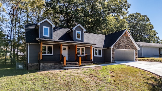 cape cod house with covered porch, a front yard, and a garage