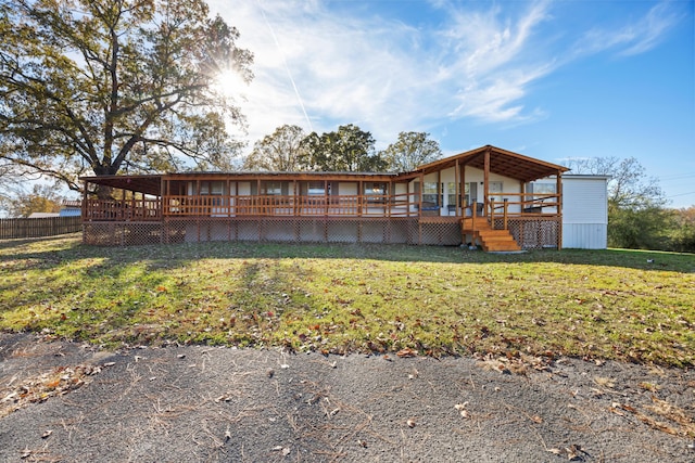 rear view of property featuring a lawn