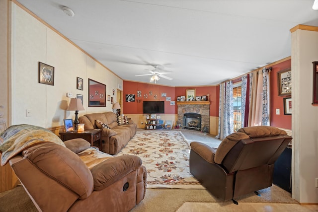 living room with ceiling fan, crown molding, and light colored carpet