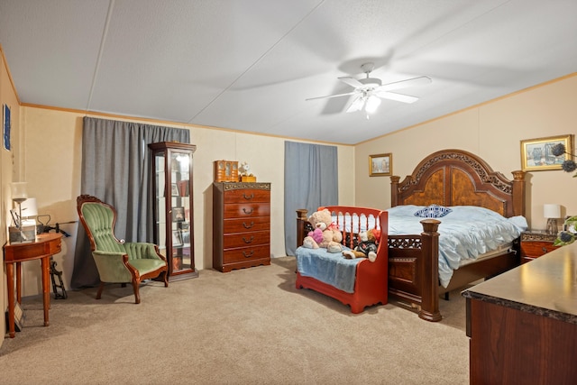 bedroom featuring ornamental molding, a textured ceiling, light colored carpet, and ceiling fan