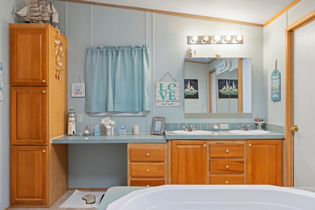 bathroom with vaulted ceiling, a textured ceiling, vanity, crown molding, and a tub to relax in