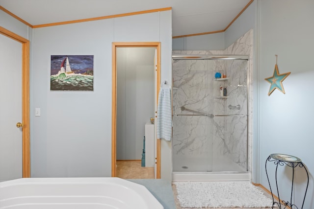 bathroom featuring a shower with door, vaulted ceiling, and ornamental molding