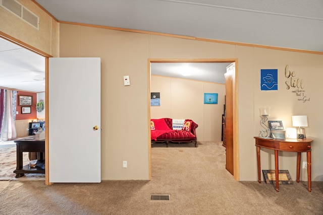 hallway with carpet, a textured ceiling, crown molding, and vaulted ceiling