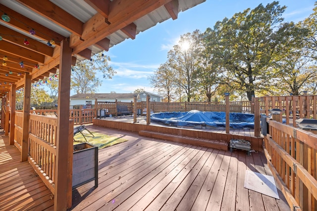 wooden deck featuring a covered pool