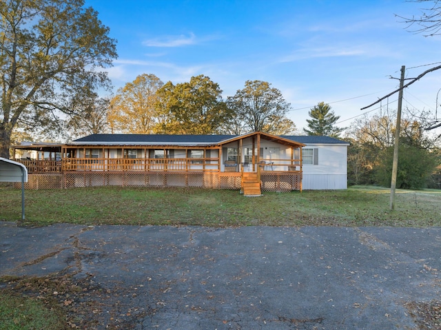 view of front of property featuring a front yard and a sunroom