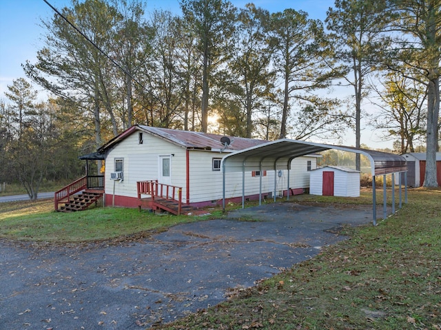 view of home's exterior featuring a storage shed and a carport