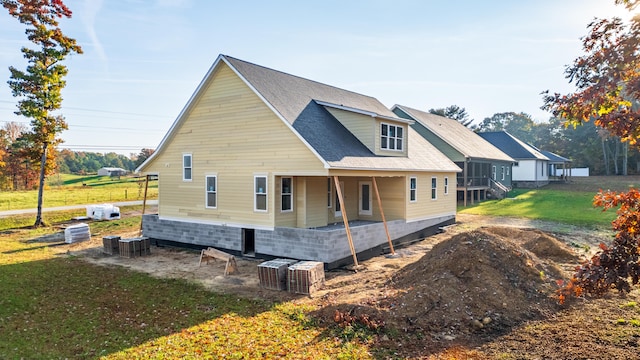 view of side of home with a sunroom and a yard