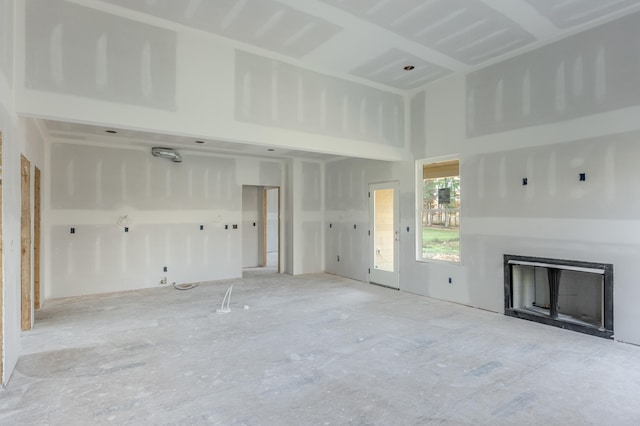 unfurnished living room with a towering ceiling