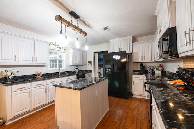 kitchen featuring black appliances, dark hardwood / wood-style floors, washer / clothes dryer, a center island, and white cabinets