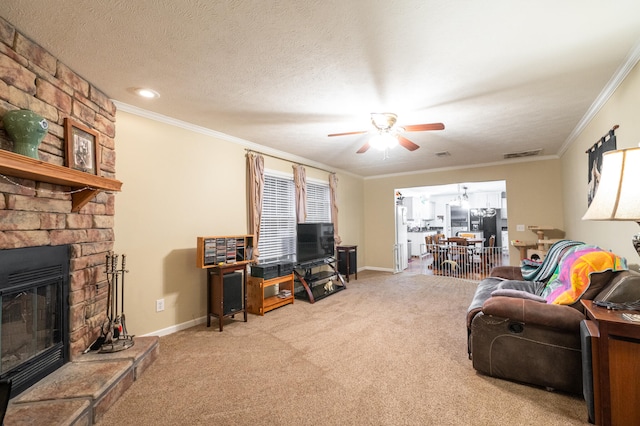 carpeted living room with a fireplace, ceiling fan, a textured ceiling, and crown molding