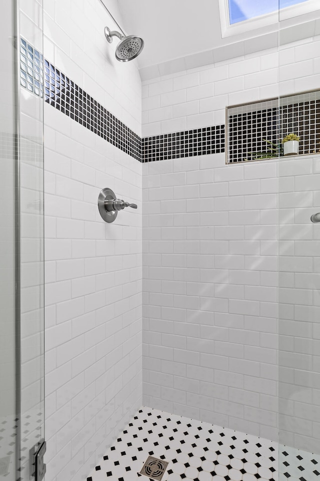 bathroom with tiled shower