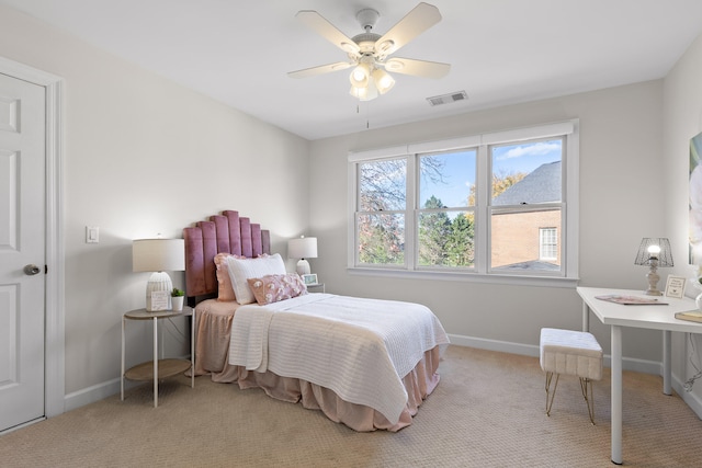 bedroom with ceiling fan and light carpet