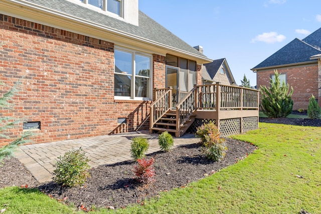 rear view of house with a yard, a patio, and a wooden deck