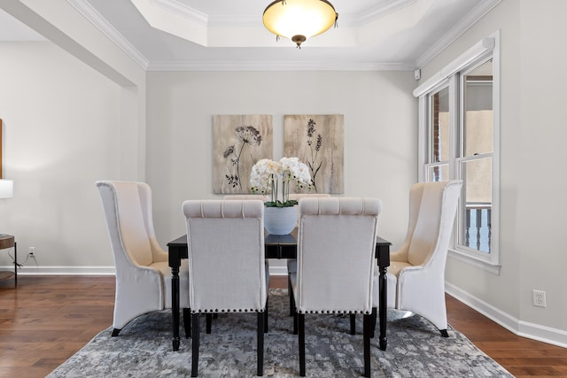 dining area featuring dark hardwood / wood-style flooring, crown molding, and a wealth of natural light