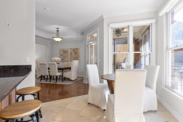 dining space with light wood-type flooring and crown molding