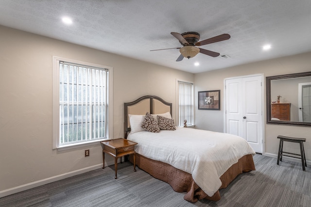 bedroom featuring a textured ceiling, ceiling fan, and a closet