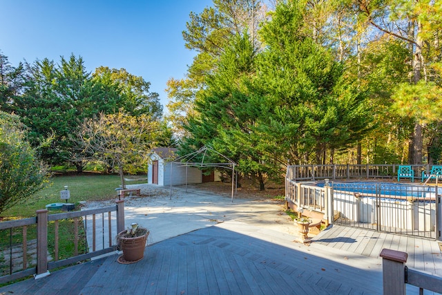 view of patio featuring a swimming pool side deck and a storage shed