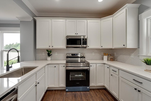 1318 Unity Dr NE, Cleveland, TN 37312 - kitchen featuring stainless steel appliances, a sink, white cabinets, decorative backsplash, and crown molding