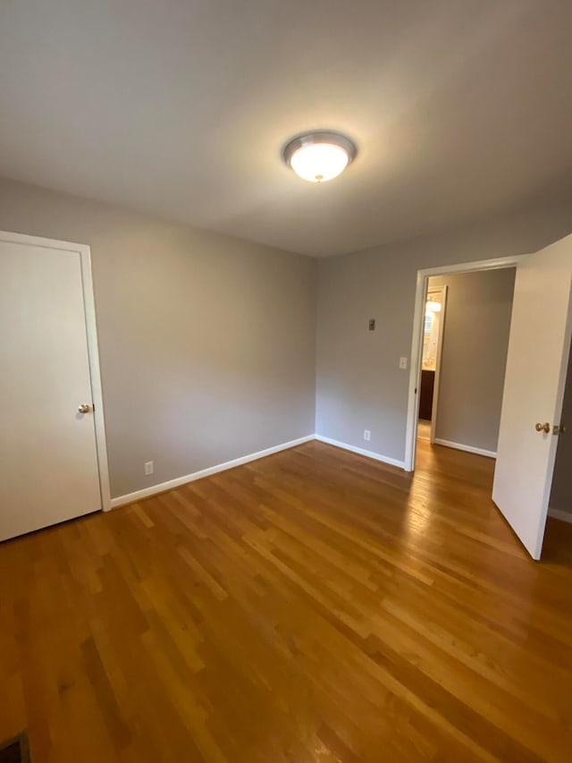 empty room with wood-type flooring