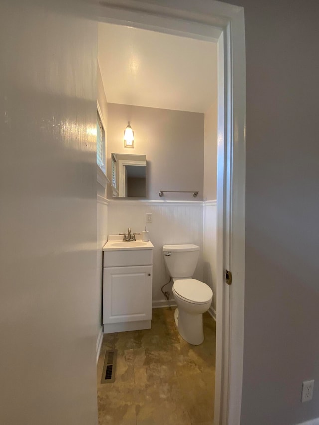 bathroom with toilet and vanity