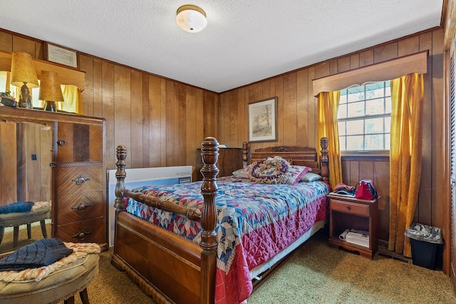 carpeted bedroom with wood walls and a textured ceiling