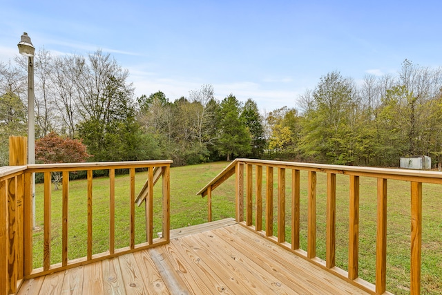 wooden deck featuring a lawn