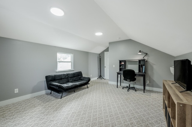 carpeted office with lofted ceiling