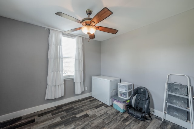 interior space with ceiling fan and dark hardwood / wood-style flooring