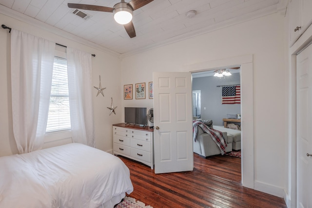 bedroom featuring dark wood-type flooring, crown molding, and ceiling fan