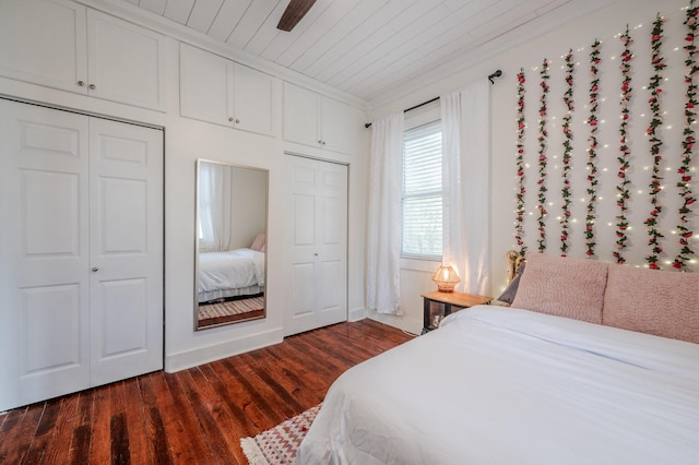 bedroom with ceiling fan, wooden ceiling, and dark hardwood / wood-style flooring