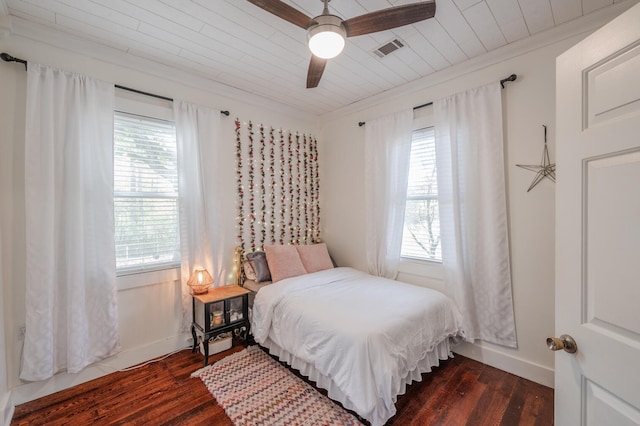 bedroom featuring dark wood-type flooring, ceiling fan, and multiple windows