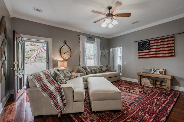 living room featuring ornamental molding, dark wood-type flooring, and ceiling fan