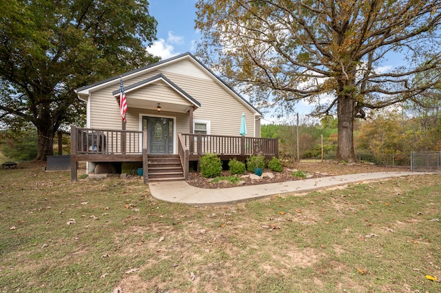 view of front facade featuring a front lawn and a deck