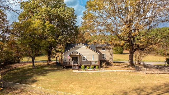 view of front facade with a front lawn and a wooden deck