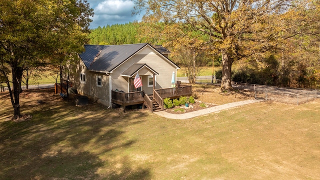 view of front of house with a wooden deck and a front yard