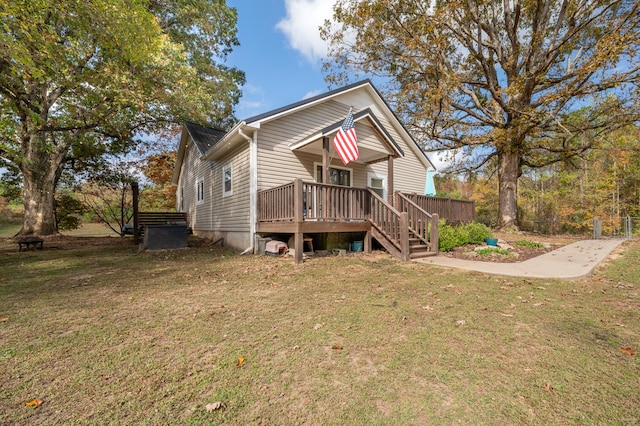 view of front of home featuring a deck and a front lawn