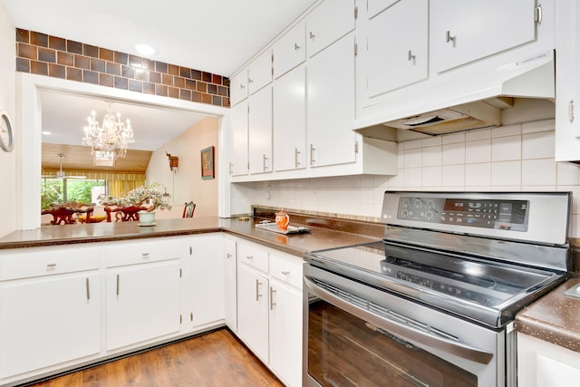 kitchen with light hardwood / wood-style flooring, a notable chandelier, electric range, and white cabinets