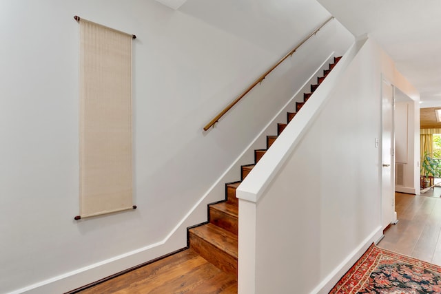 stairs with hardwood / wood-style floors