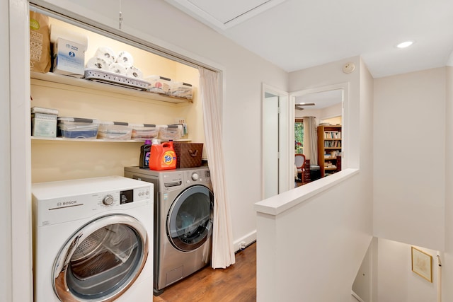 laundry room with dark wood-type flooring and washing machine and dryer