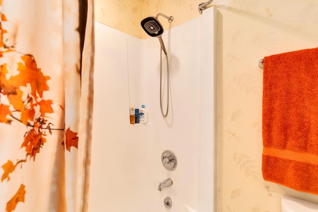 interior details featuring shower / bath combo