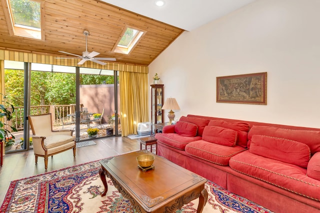 living room with light hardwood / wood-style flooring, ceiling fan, plenty of natural light, and vaulted ceiling