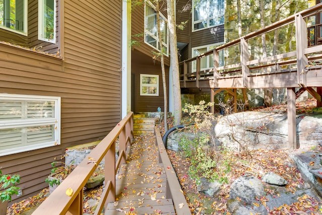 entrance to property featuring a wooden deck