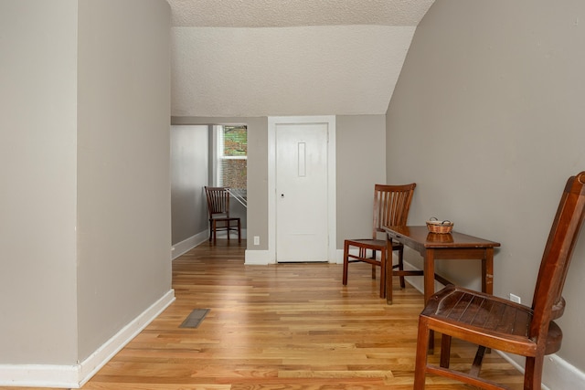 sitting room with a textured ceiling and light hardwood / wood-style floors