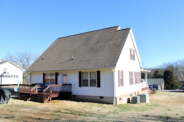 view of front of property with cooling unit, a front lawn, and a deck