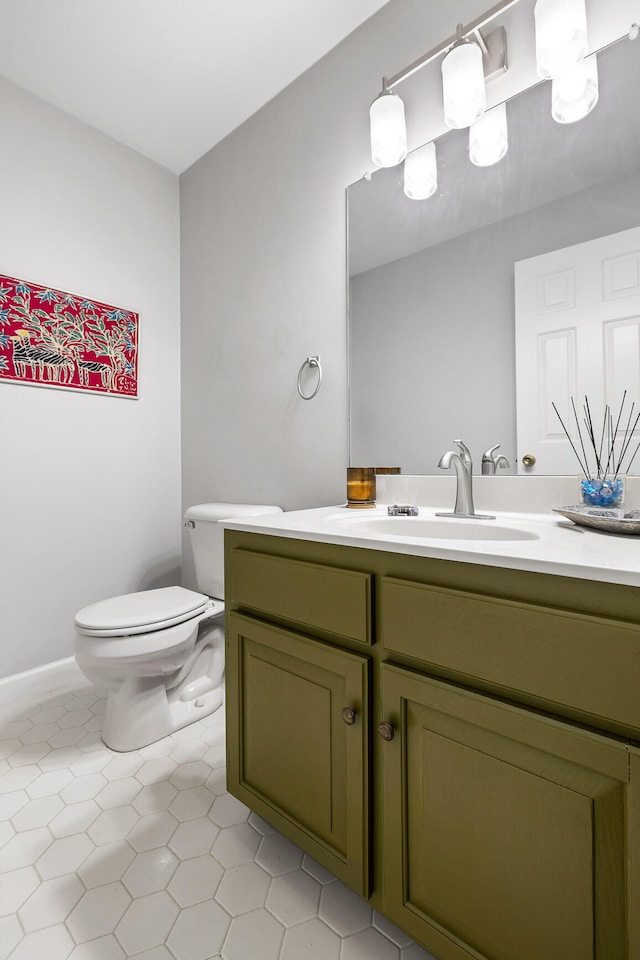 bathroom featuring vanity, toilet, and tile patterned flooring