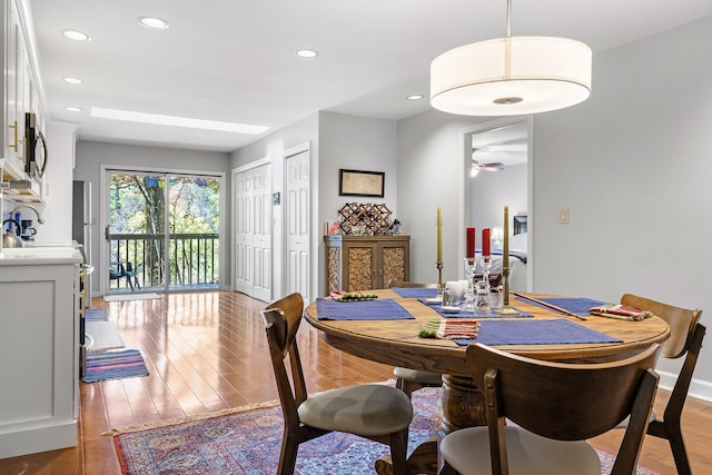 dining area featuring light hardwood / wood-style flooring and ceiling fan