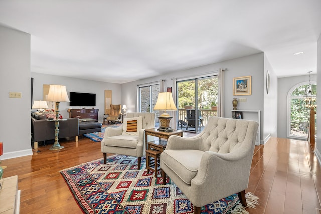 living room with a notable chandelier and hardwood / wood-style floors